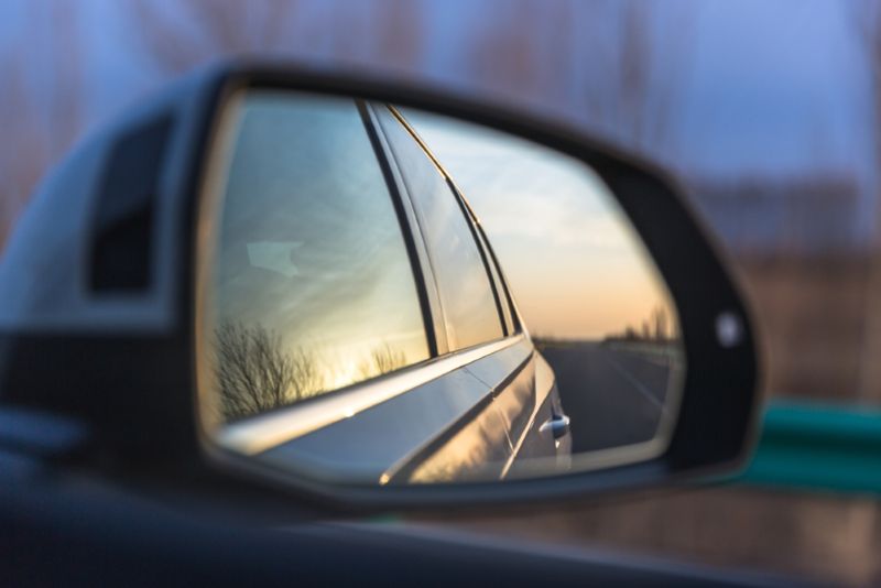 side mirror of a car driving in the evening