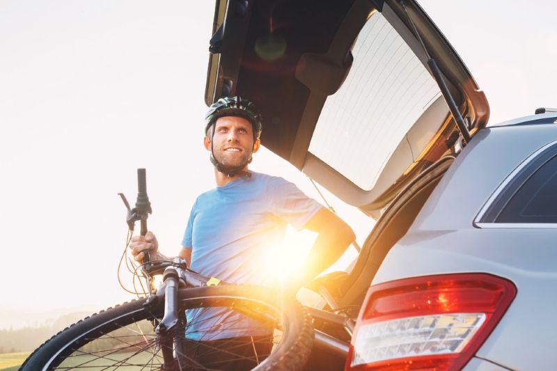grabbing bicycle from the trunk of a car
